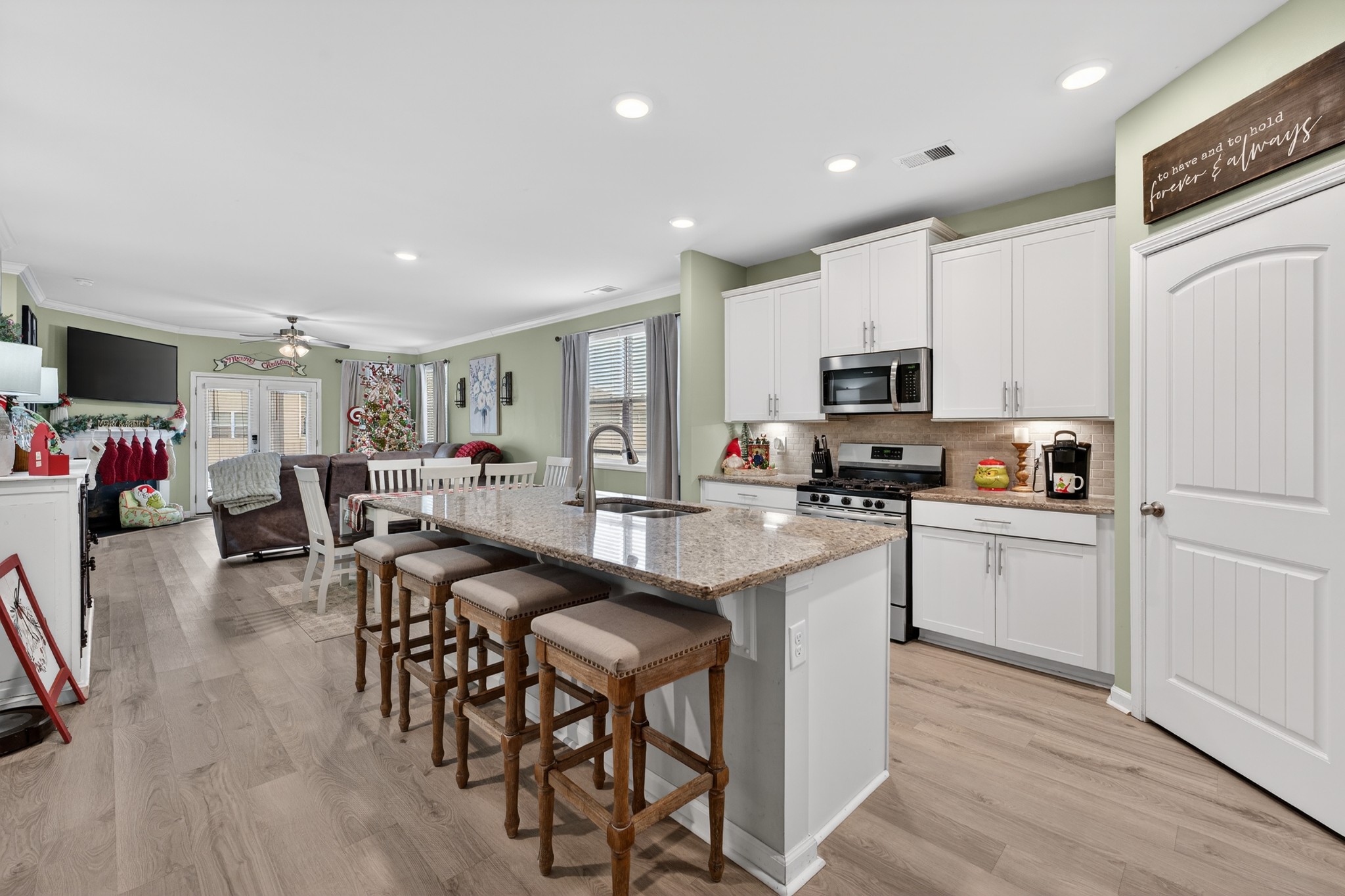306 William Dylan Drive Murfreesboro, TN 37129 - Photo 7 of 47 a kitchen with white cabinets and chairs
