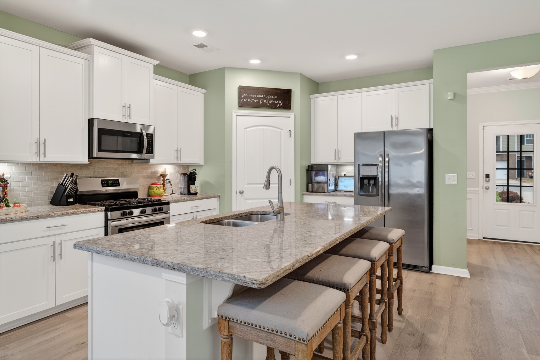 306 William Dylan Drive Murfreesboro, TN 37129 - Photo 8 of 47 a kitchen with stainless steel appliances granite countertop a stove a refrigerator a sink a stove and white cabinets with wooden floor