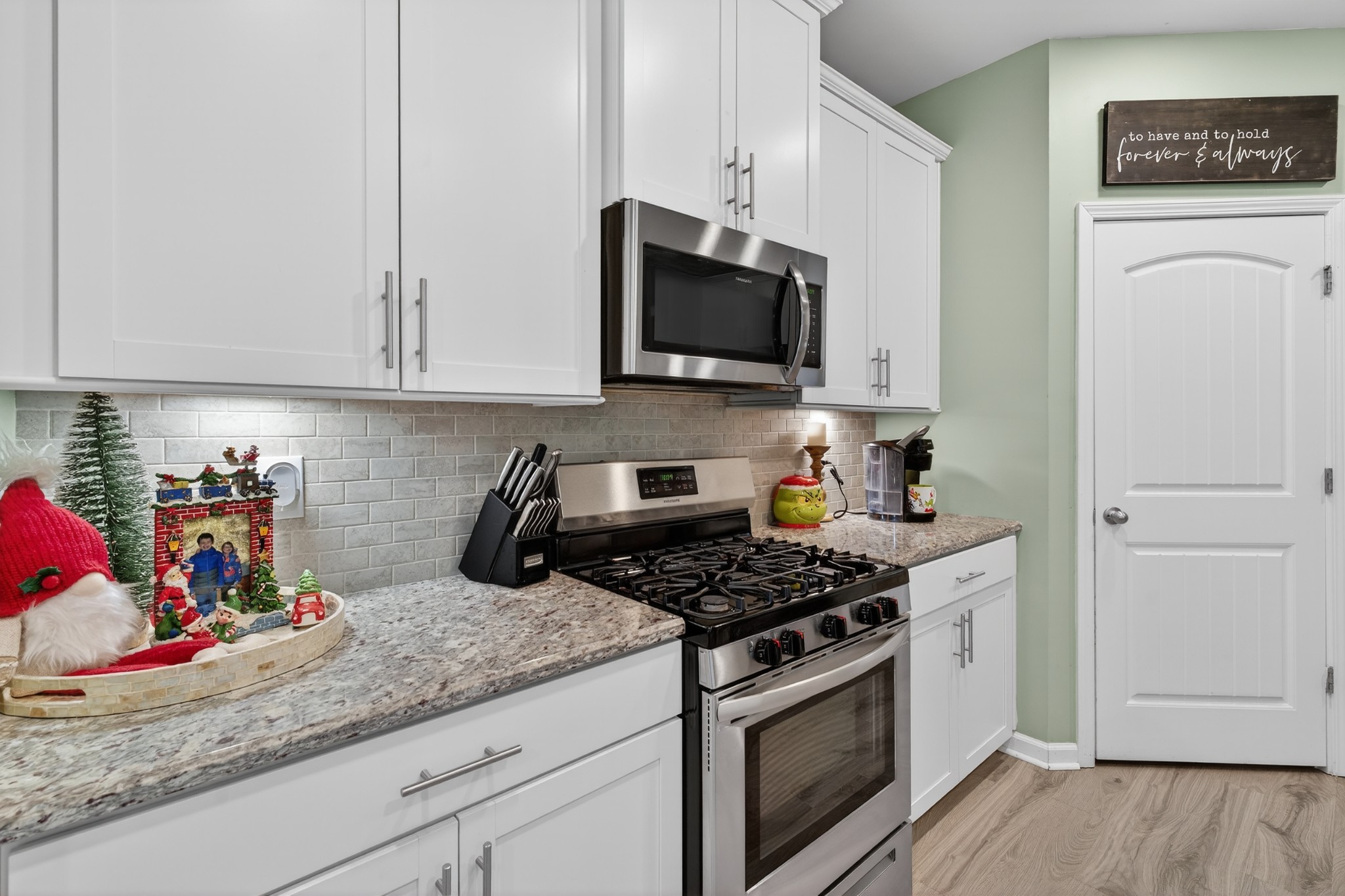 306 William Dylan Drive Murfreesboro, TN 37129 - Photo 10 of 47 a kitchen with white cabinets and a stove with wooden floor