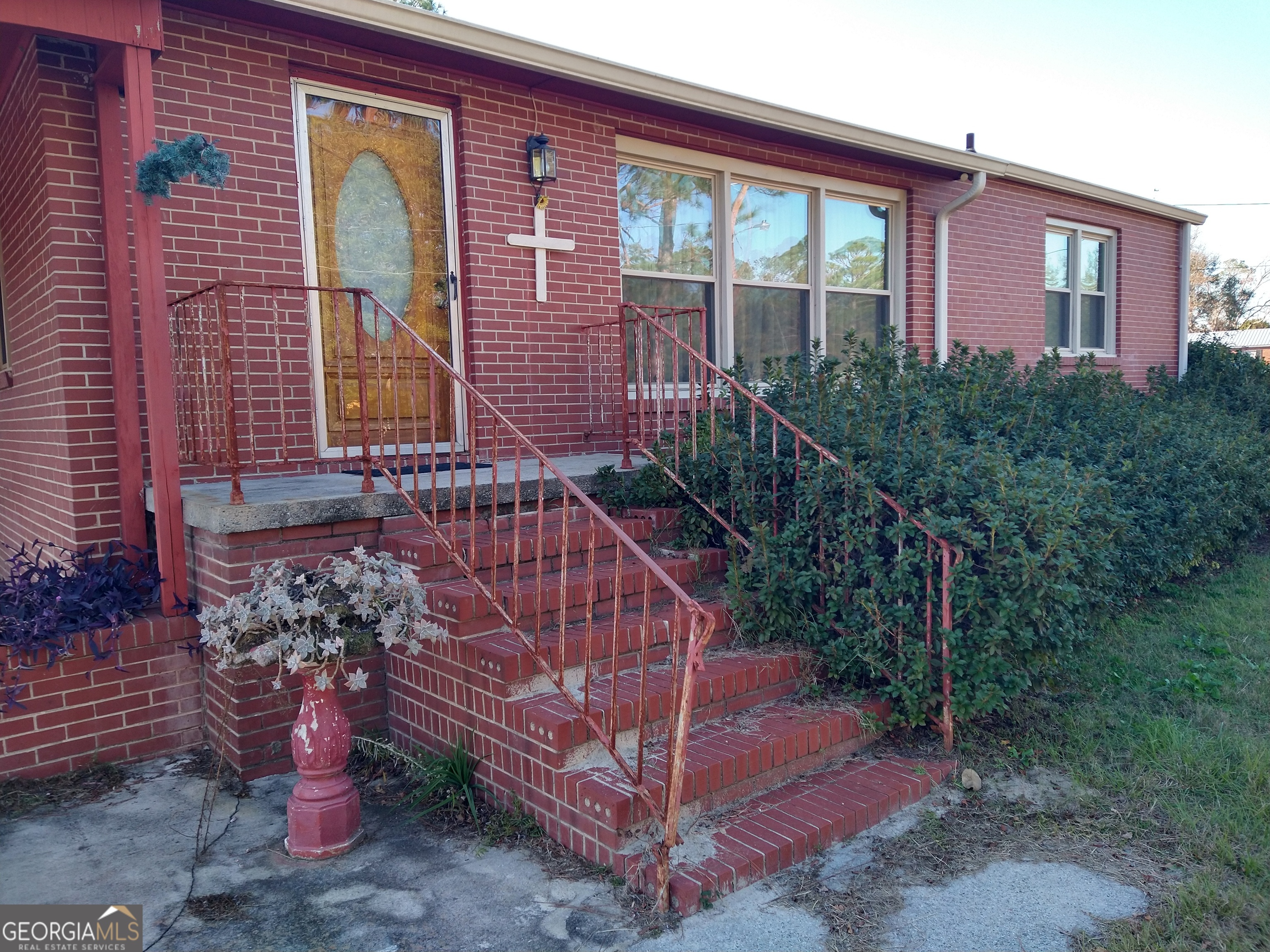 a view of a brick house with a yard