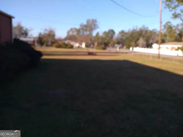 a view of ocean and a yard