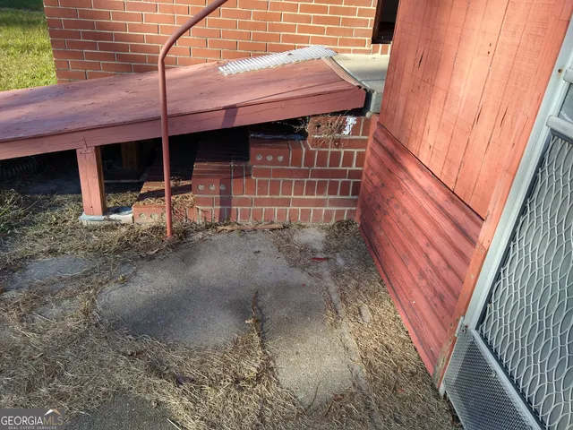 a view of a backyard with a small cabin and chair