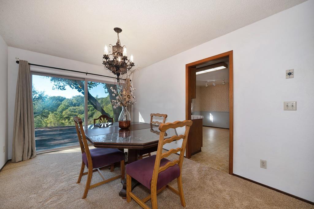 4656 Cosumnes View Trail Placerville, CA 95667 - Photo 13 of 58 a dining room with furniture a large window and a chandelier