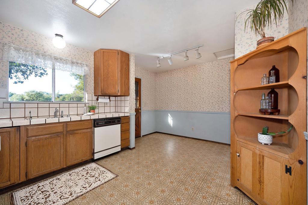 4656 Cosumnes View Trail Placerville, CA 95667 - Photo 17 of 58 a kitchen with stainless steel appliances granite countertop a stove a sink and a microwave