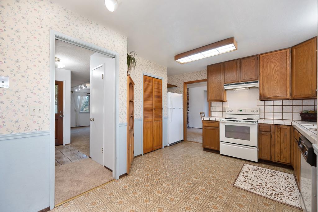 4656 Cosumnes View Trail Placerville, CA 95667 - Photo 22 of 58 a kitchen with stainless steel appliances granite countertop a refrigerator and a stove top oven