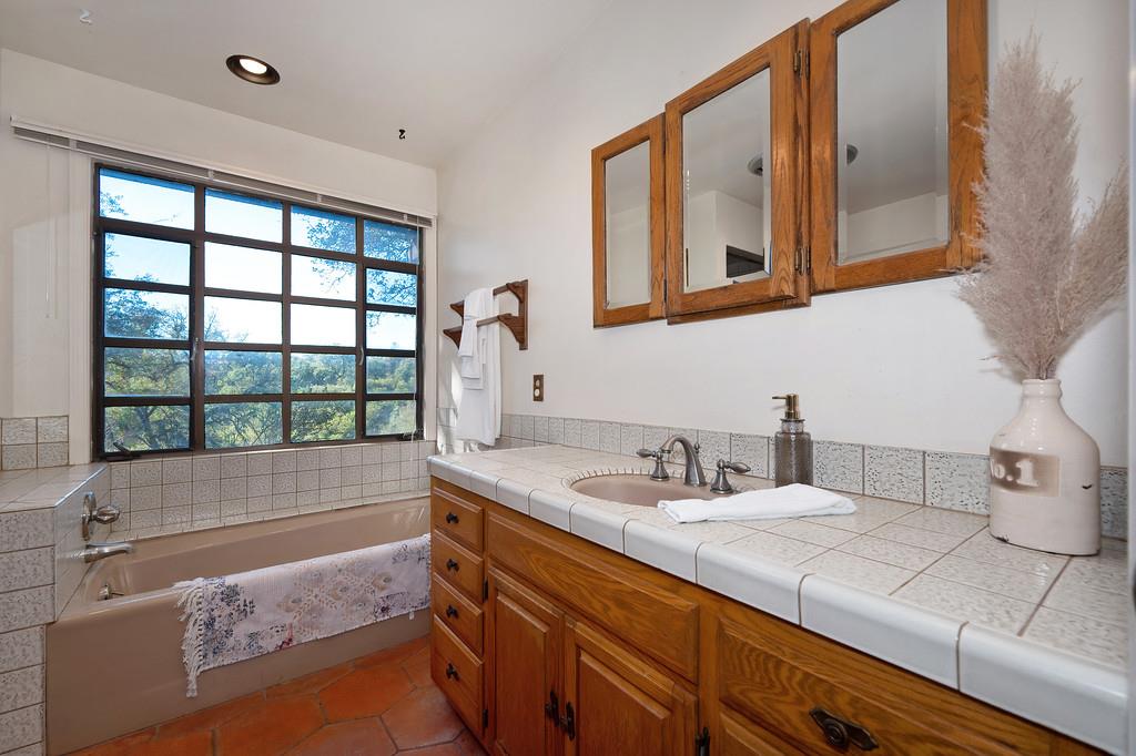 4656 Cosumnes View Trail Placerville, CA 95667 - Photo 27 of 58 a bathroom with a double vanity sink and mirror