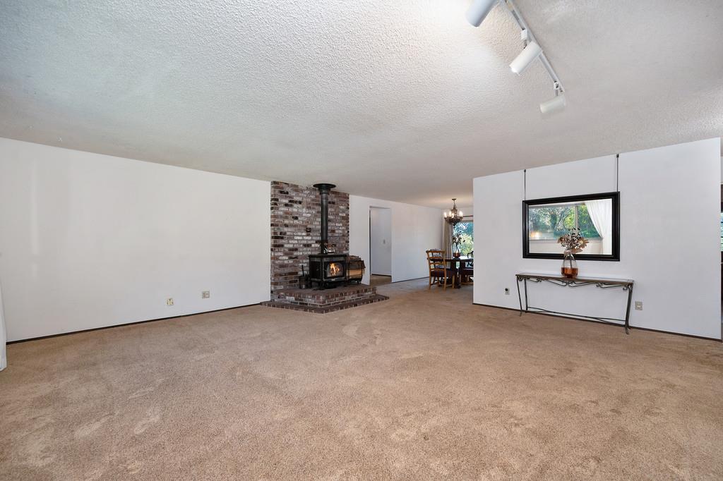 4656 Cosumnes View Trail Placerville, CA 95667 - Photo 10 of 58 a view of a livingroom with furniture and a flat screen tv