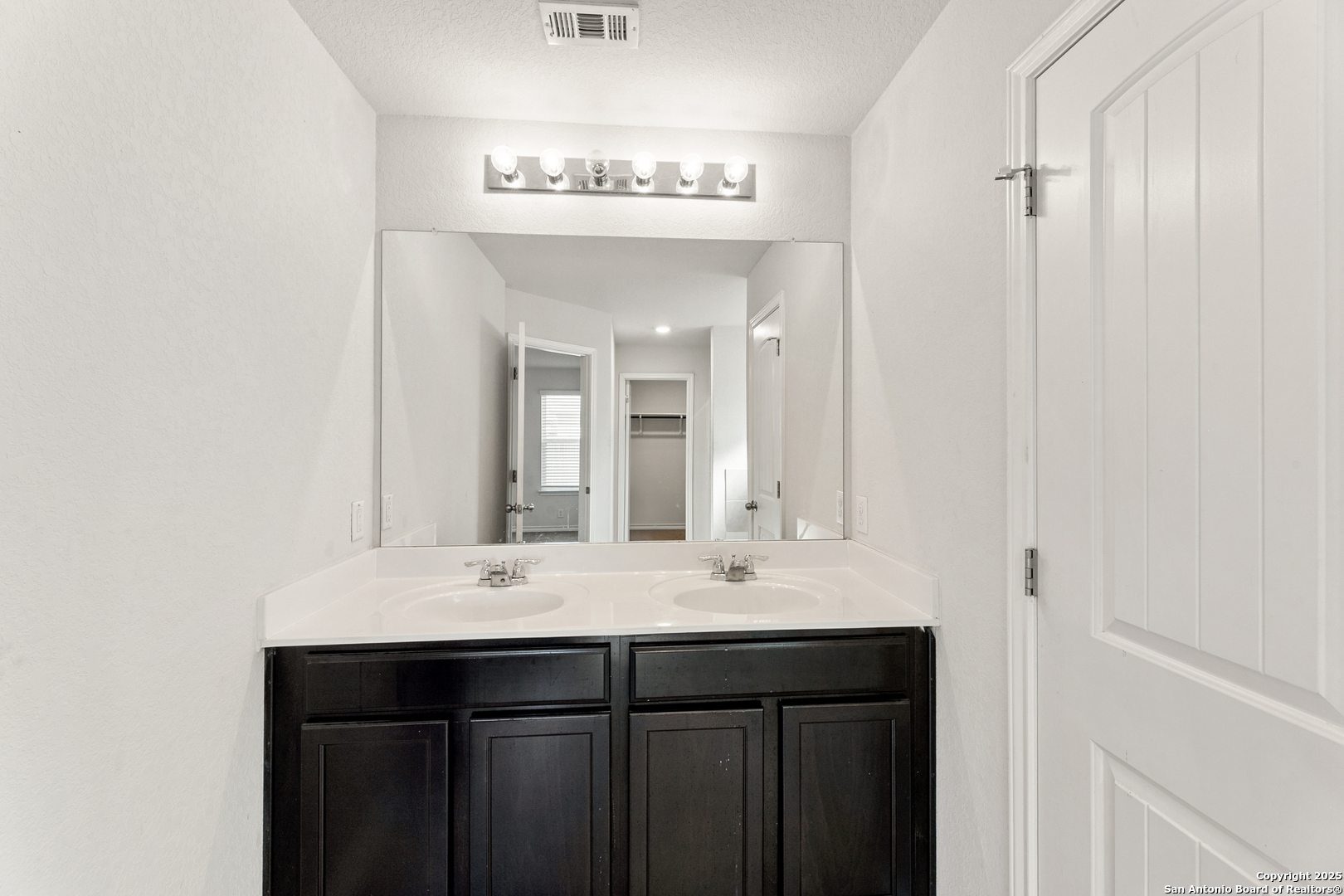 9711 Bratten Rise San Antonio, TX 78254 - Photo 15 of 19 a bathroom with a sink and a mirror