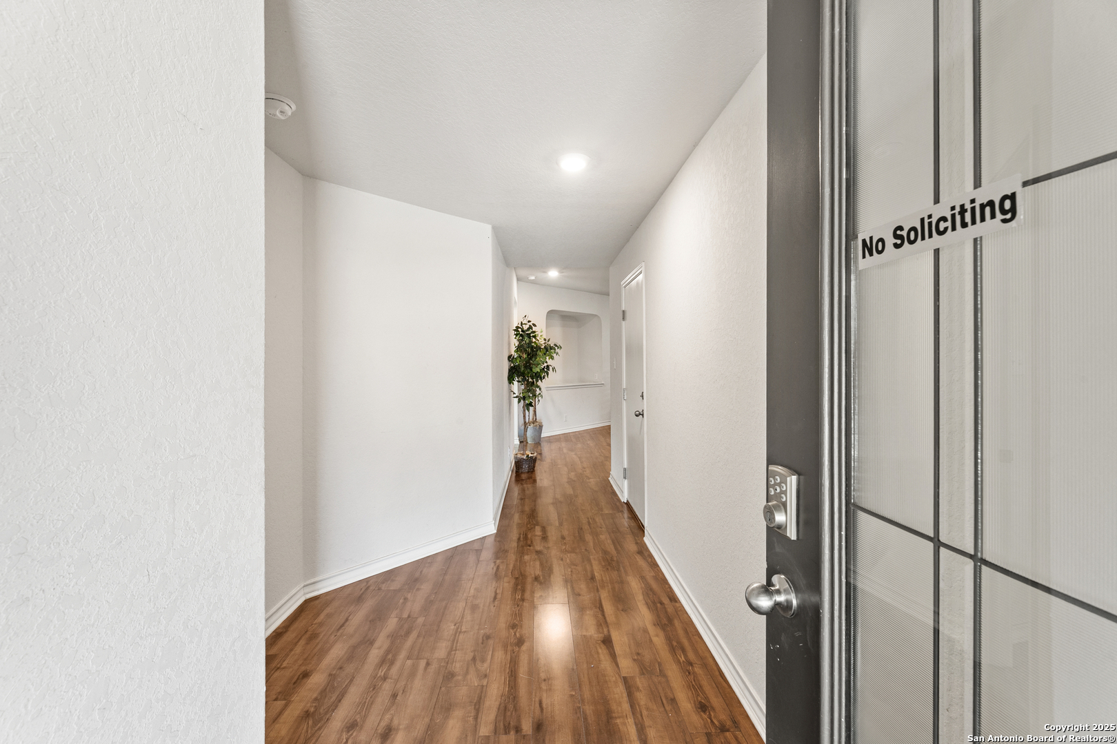 9711 Bratten Rise San Antonio, TX 78254 - Photo 18 of 19 a view of a hallway with wooden floor and staircase