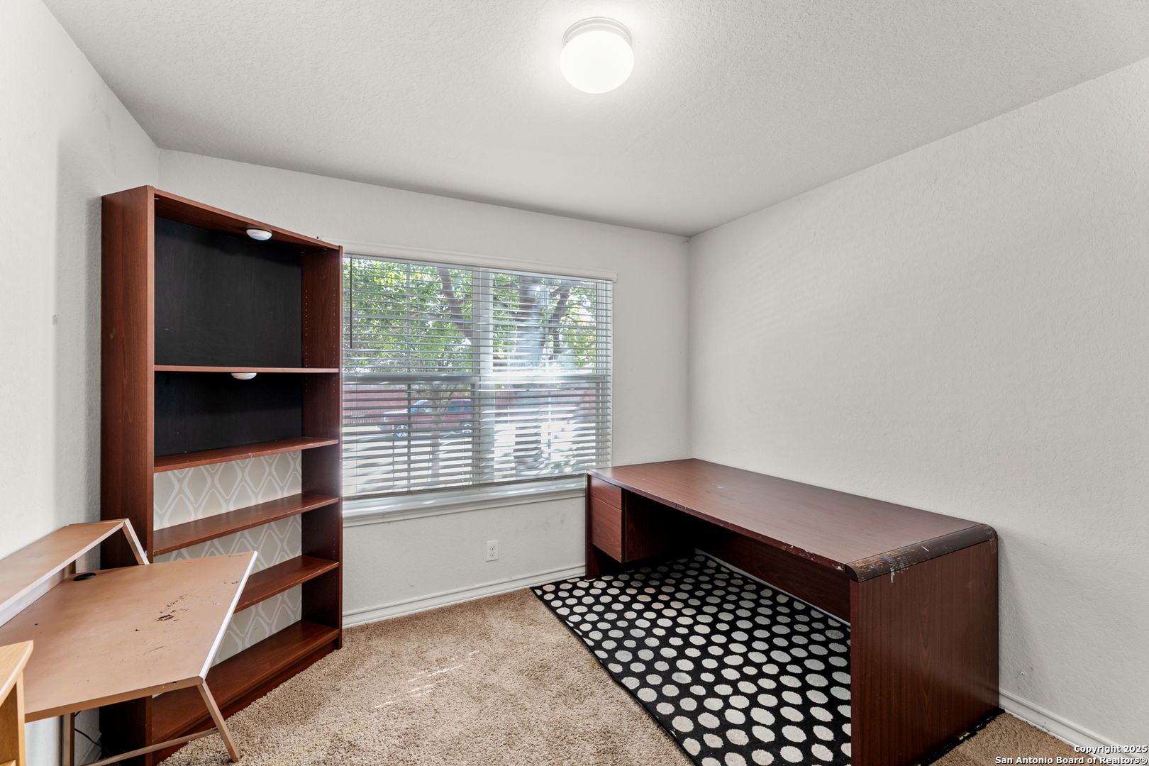 9711 Bratten Rise San Antonio, TX 78254 - Photo 2 of 19 a bedroom with a bed and a window