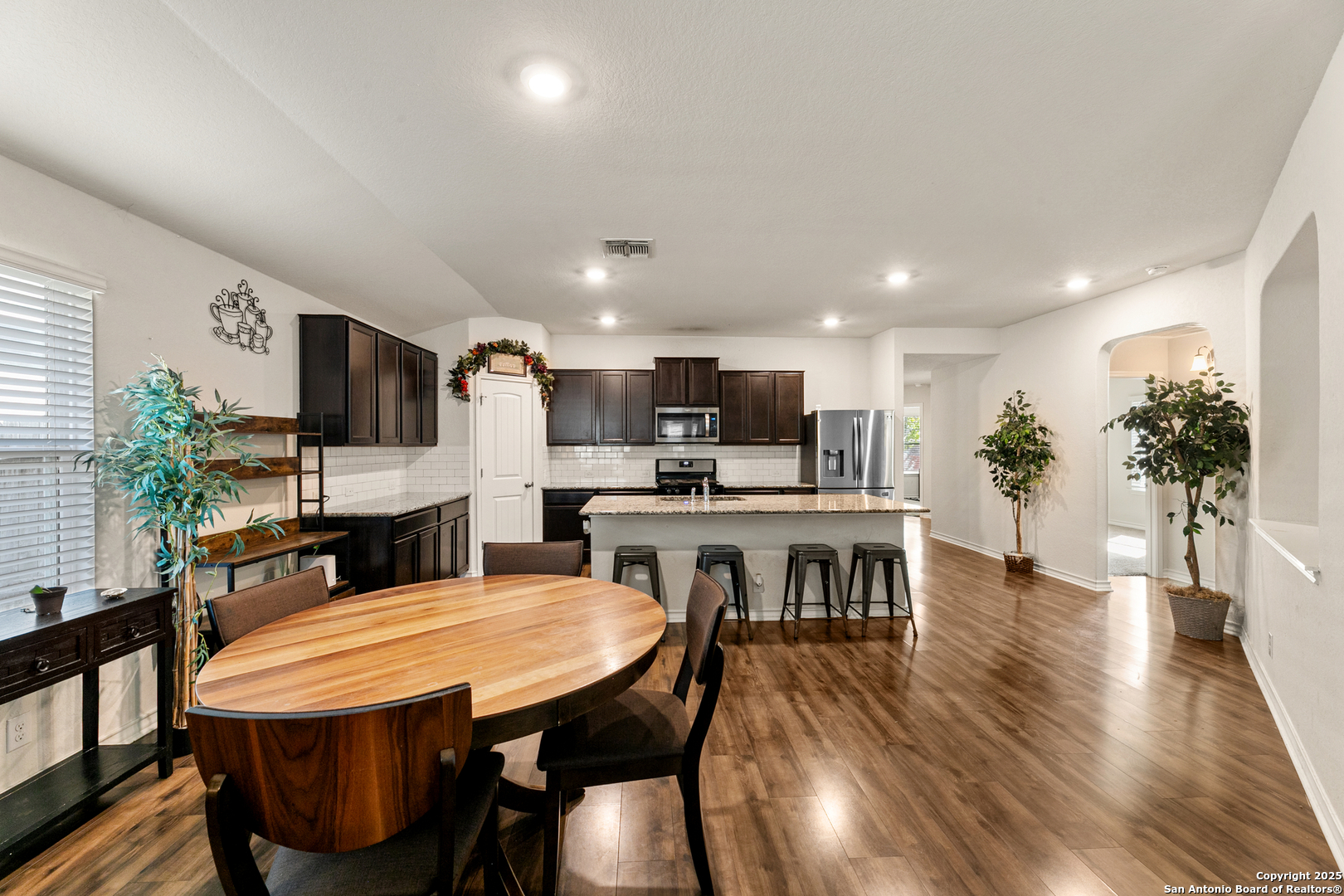 9711 Bratten Rise San Antonio, TX 78254 - Photo 7 of 19 a dining room with furniture and wooden floor