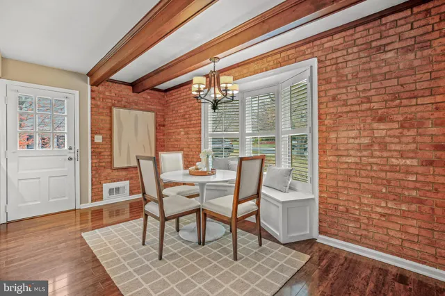 a dining room with furniture and wooden floor