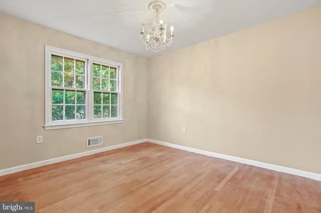 a view of wooden floor and windows in a room