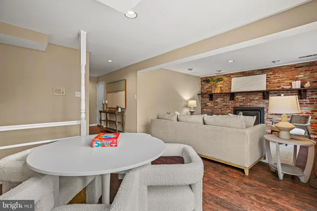 a living room with furniture and kitchen view