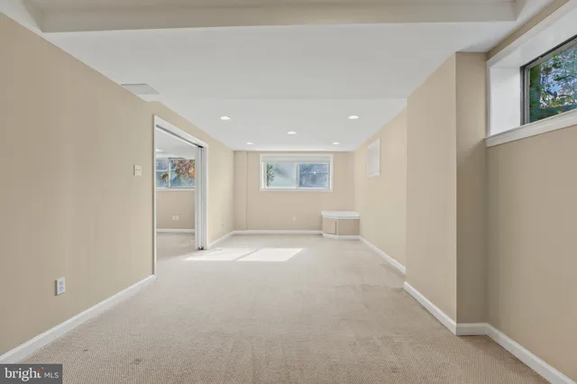 an empty room with a empty space and windows