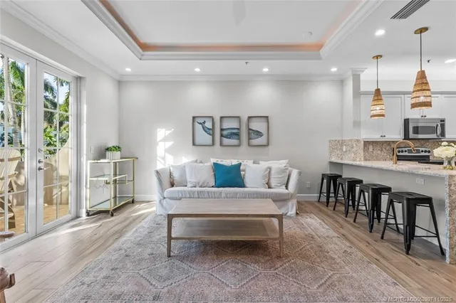 a living room with furniture a large window and a table