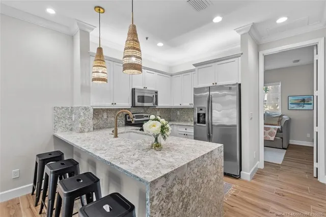 a kitchen with kitchen island a counter top space appliances and cabinets