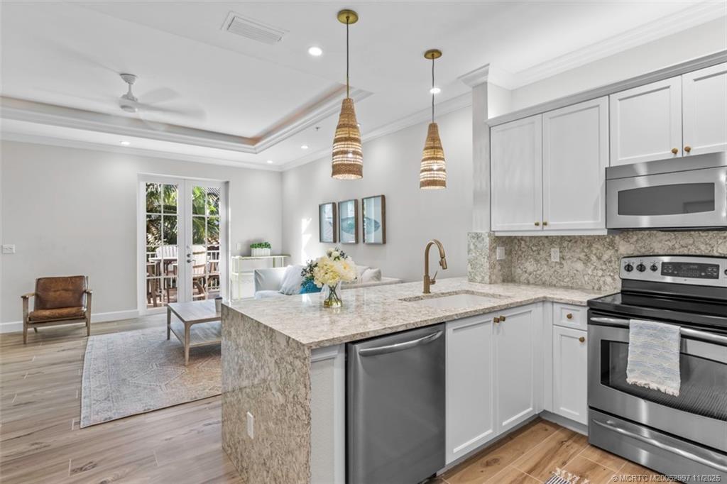 1577 Bow Line Road Fort Pierce, FL 34949 - Photo 17 of 49 a kitchen with a sink stove and cabinets