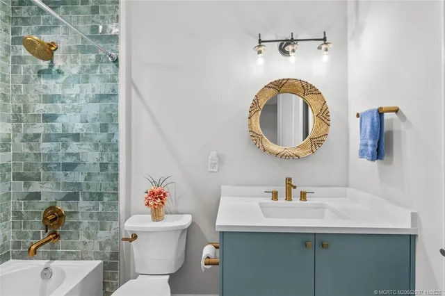 a bathroom with a sink mirror and toilet