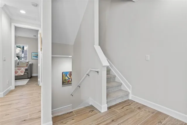 a view of entryway with wooden floor and stairs