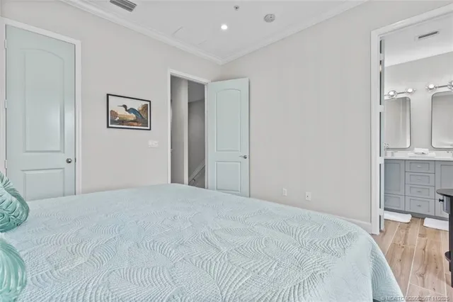 a bedroom with a bed and a view of kitchen