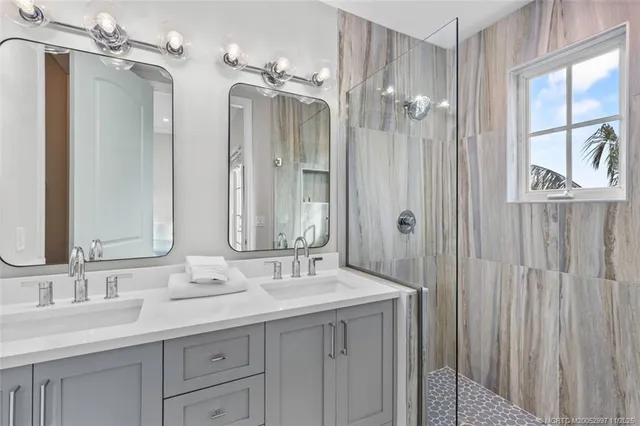 a bathroom with a double vanity sink a mirror a and a window