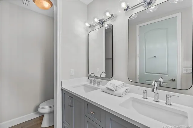 a bathroom with a double vanity sink and a mirror