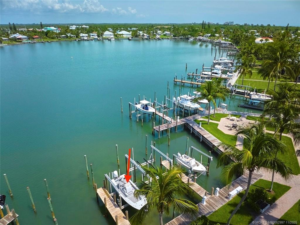 1577 Bow Line Road Fort Pierce, FL 34949 - Photo 35 of 49 a view of a lake with lawn chairs