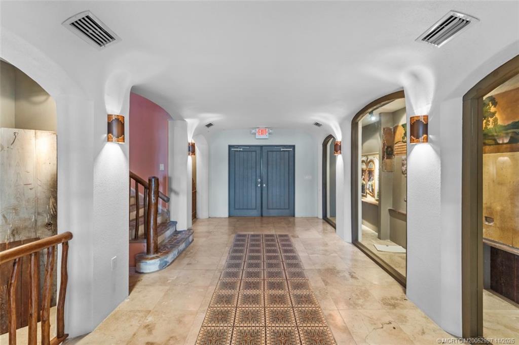 1577 Bow Line Road Fort Pierce, FL 34949 - Photo 44 of 49 a view of a hallway with wooden floor and windows