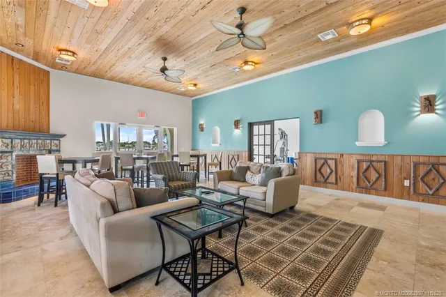 a living room with furniture and kitchen view
