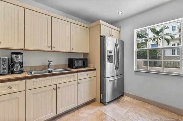 a kitchen with stainless steel appliances granite countertop a refrigerator sink and cabinets