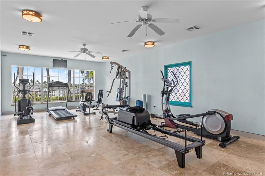1577 Bow Line Road Fort Pierce, FL 34949 - Photo 48 of 49 a living room with furniture gym equipment and a large window