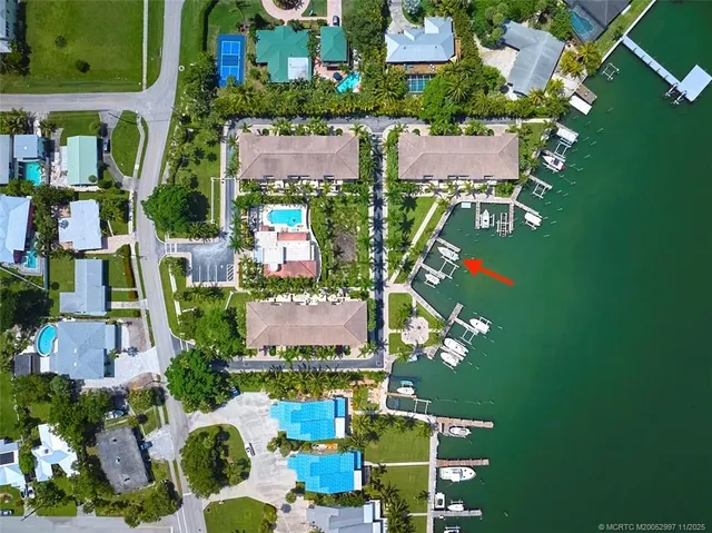 an aerial view of residential houses with outdoor space and street view