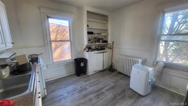 a room with a window and wooden floor