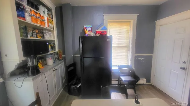 a view of walk in closet with wooden floor and a cabinet