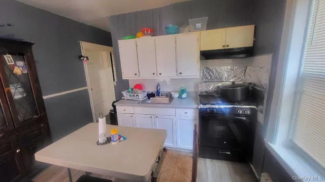 a kitchen with stainless steel appliances a sink microwave and cabinets