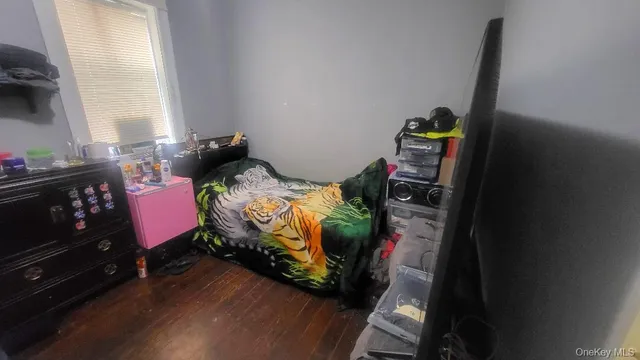 a bed sitting in a bedroom next to a window