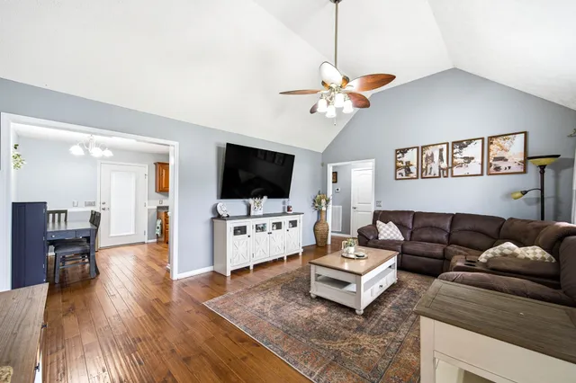 a large kitchen with stainless steel appliances granite countertop a stove a sink and a microwave