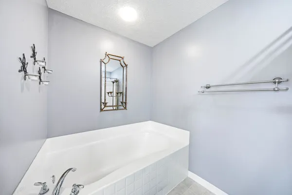 a bathroom with a toilet a sink and a large mirror
