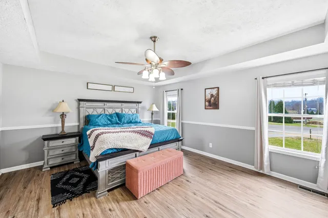 a bedroom with furniture and flat screen tv