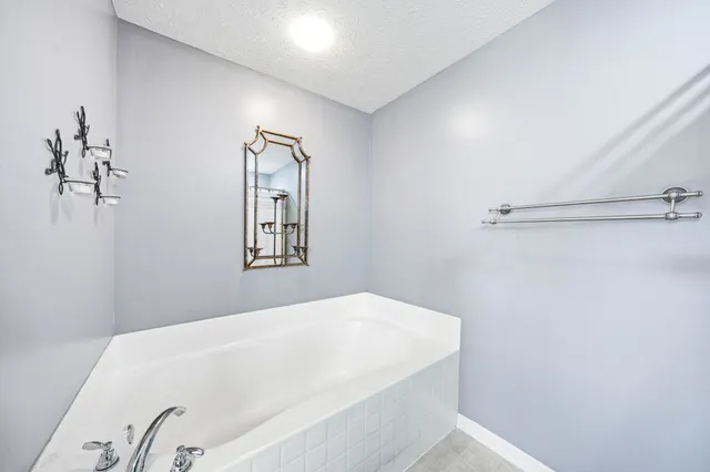 a bathroom with a toilet a sink and a large mirror