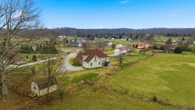 an aerial view of residential houses with outdoor space and swimming pool