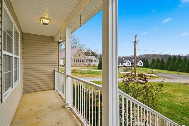 a living room with furniture a rug and a window
