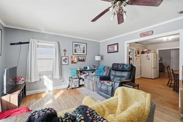 a living room with furniture a window and a flat screen tv