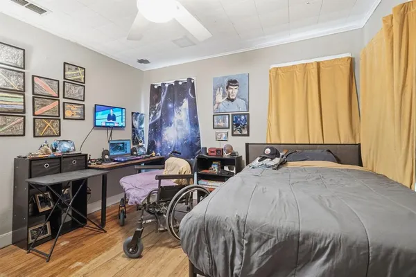a bedroom with a bed and a desk