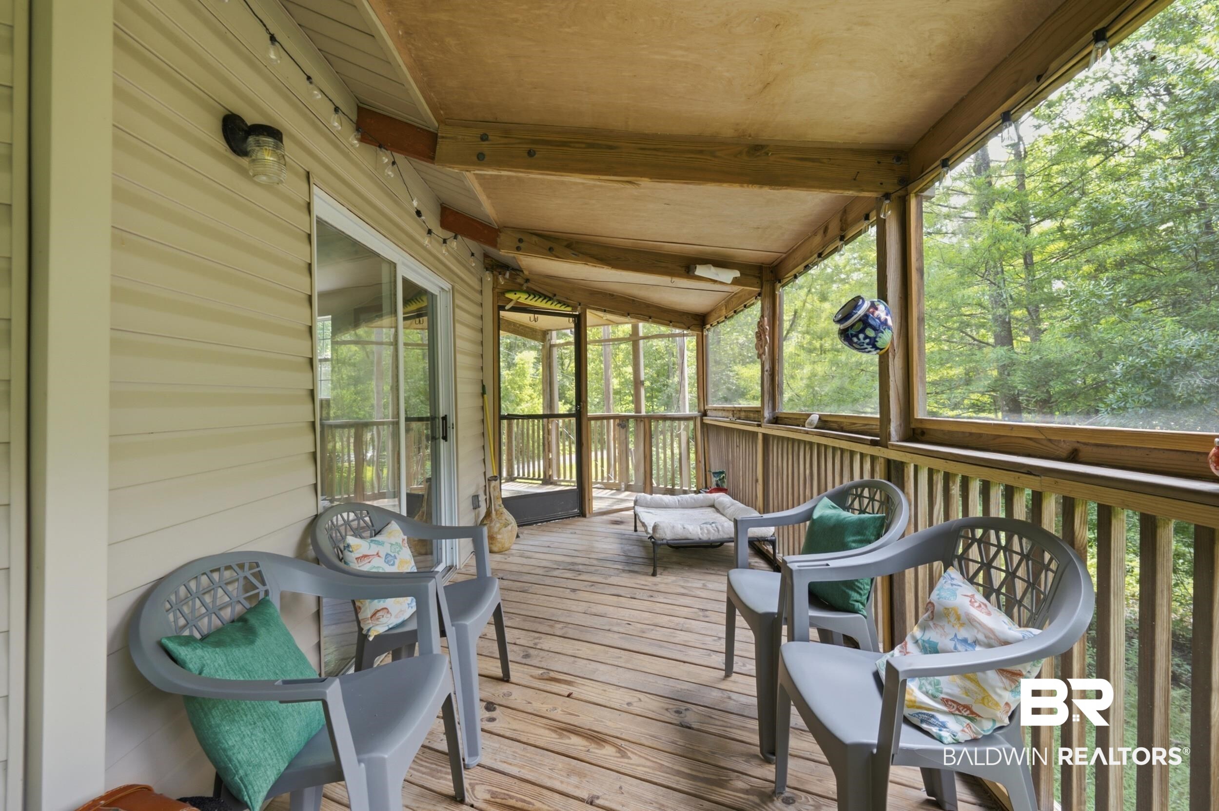 42080 Bayou Road Bay Minette, AL 36507 - Photo 10 of 43 Expansive screened porch featuring wood-finish flooring, natural wood railings, and a wood-finish ceiling