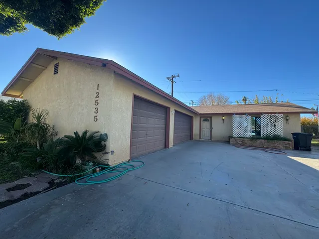 a view of a house with a yard and garage