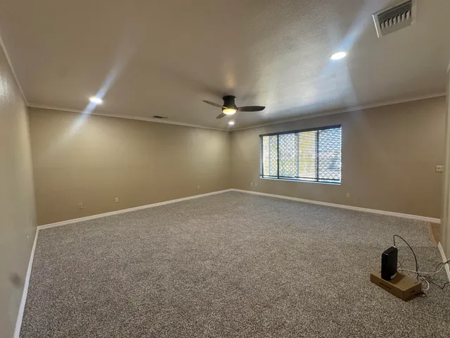 a large kitchen with a sink and wooden floor