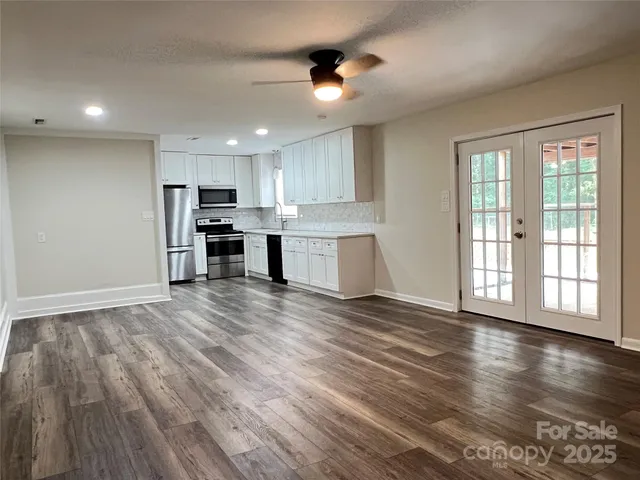 a view of a kitchen with a sink and a stove top oven