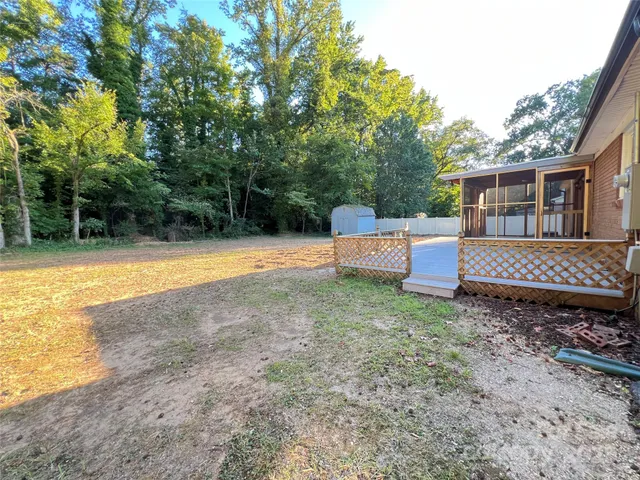 a backyard of a house with barbeque oven and outdoor seating